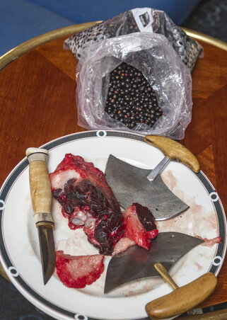 Raw seal meat with crowberries, along with regular knife and ulu, an Inuit knife used to slice meat. Raw seal meat with crowberries, along with regular knife and ulu, an Inuit knife used to slice meat.